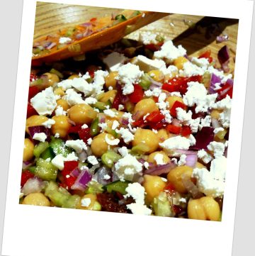 Chickpea salad with vegetables and feta cheese sprinkled on top