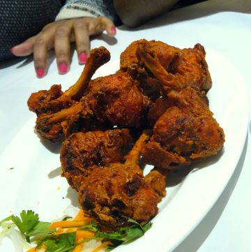 Fried chicken drumstick on white plate