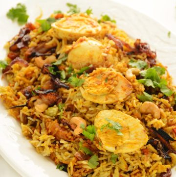 Egg biryani served on oval white plate