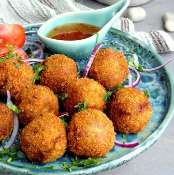 Indian style fish croquettes with dipping sauce on the side