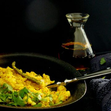 Indian style scrambled fish in black bowl