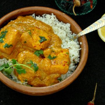 Indian fish curry served over rice in a bowl