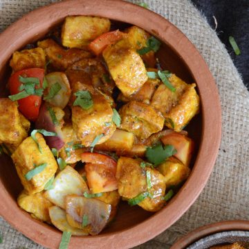 Fried shark curry in terracotta bowl