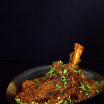 Indian lamb shanks curry served in black bowl