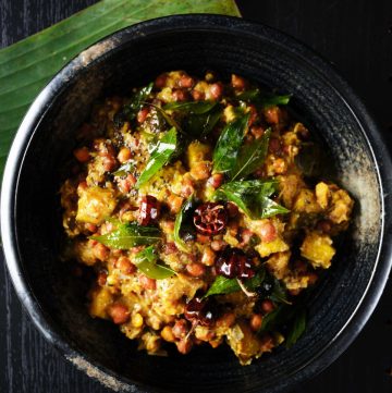 Black chickpeas, yam and plantain curry served in black bowl