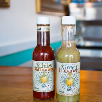 2 bottles of red and green hot sauce