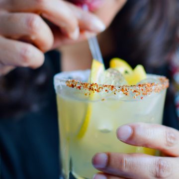 Woman holding a glass of margarita