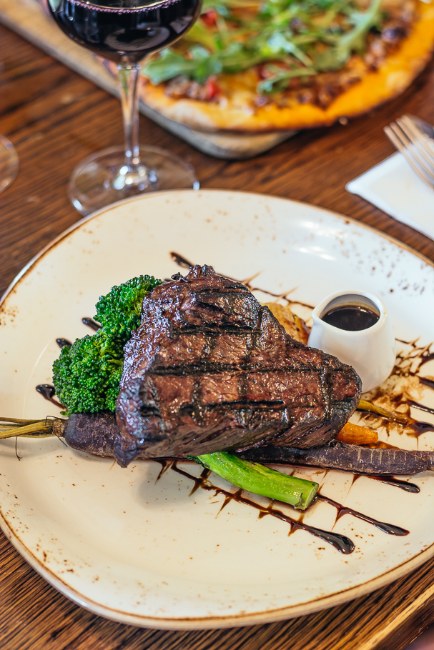 Grilled beef steak with jus and vegetables