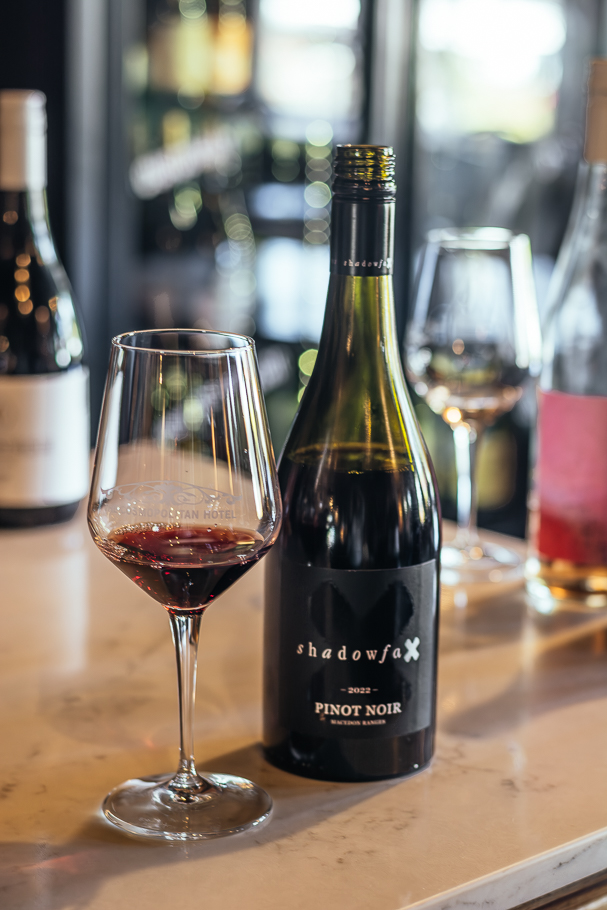 A glass and bottle of red wine